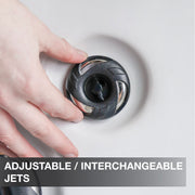 Hand adjusting a shower head with text 'Adjustable/Interchangeable Jets' on a neutral background